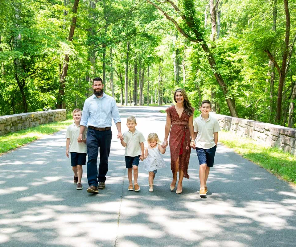 Ryan Mehaffey walking outdoors with his wife Lucie and their children